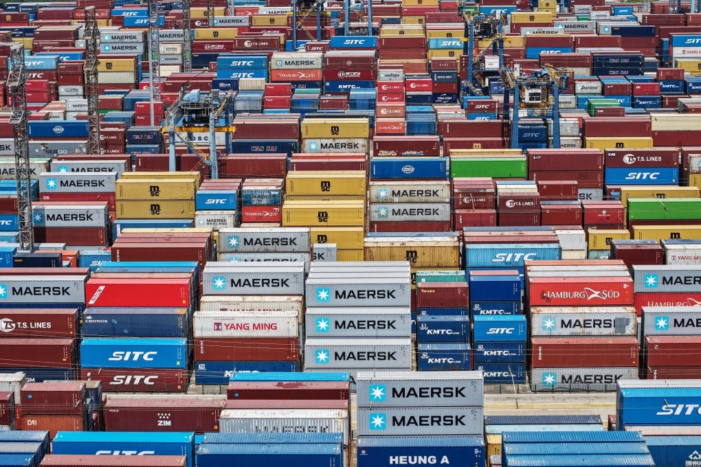 Shipping containers are seen stacked at a port in Shanghai on Sunday. The International Monetary Fund now expects China’s economy to grow by just 4 per cent this year as trade tensions with the United States persist. Photo: AFP