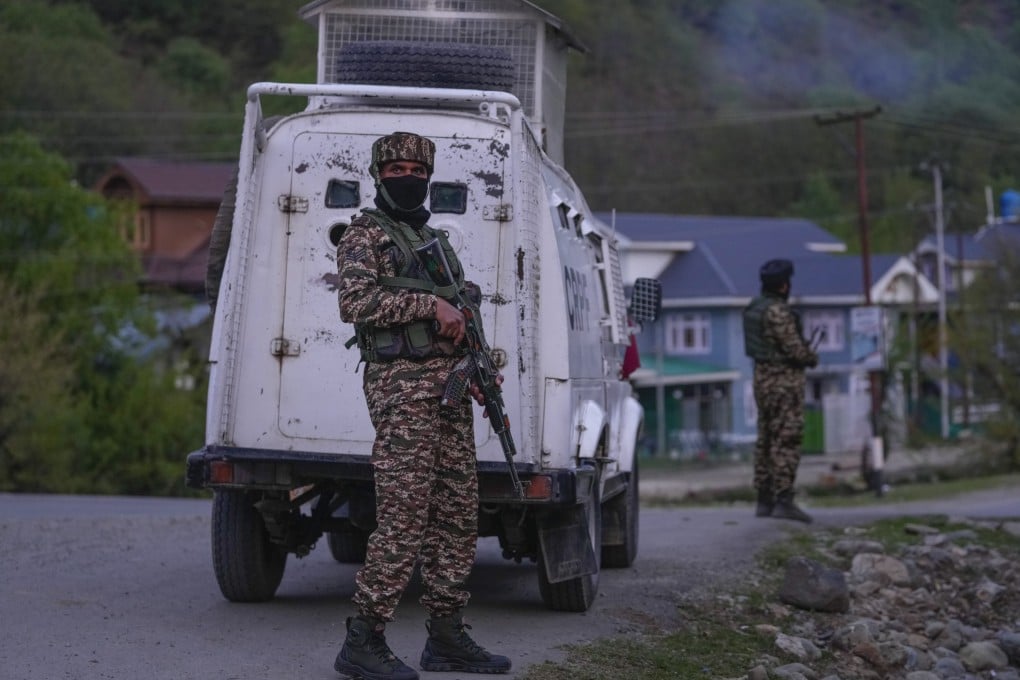 Indian security officers stand guard in south Kashmir after assailants opened fired at tourists. Photo: AP