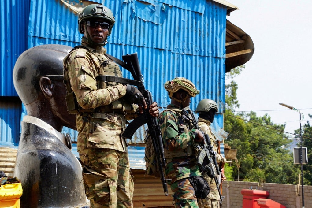 Members of the M23 rebel group stand guard as people attend a rally in Bukavu, the Democratic Republic of Congo, on February 27. Photo: Reuters