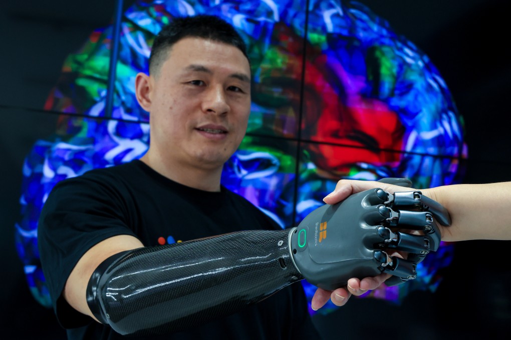 Hong Kong’s leader also met Ni Mincheng, who is testing out BrainCo’s latest pair of robotic arms. Photo: Dickson Lee