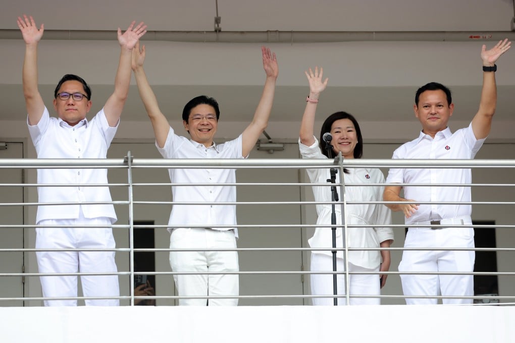 Singapore’s Prime Minister Lawrence Wong (second from left) waves with fellow People’s Action Party team members after delivering their speeches at a nomination centre on Wednesday. Photo: EPA-EFE