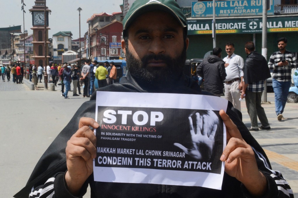 A Kashmiri trader holds a sign during a protest against the attack on tourists, following a suspected militant attack in south Kashmir’s scenic Pahalgam, in Srinagar on Wednesday. Photo: Reuters