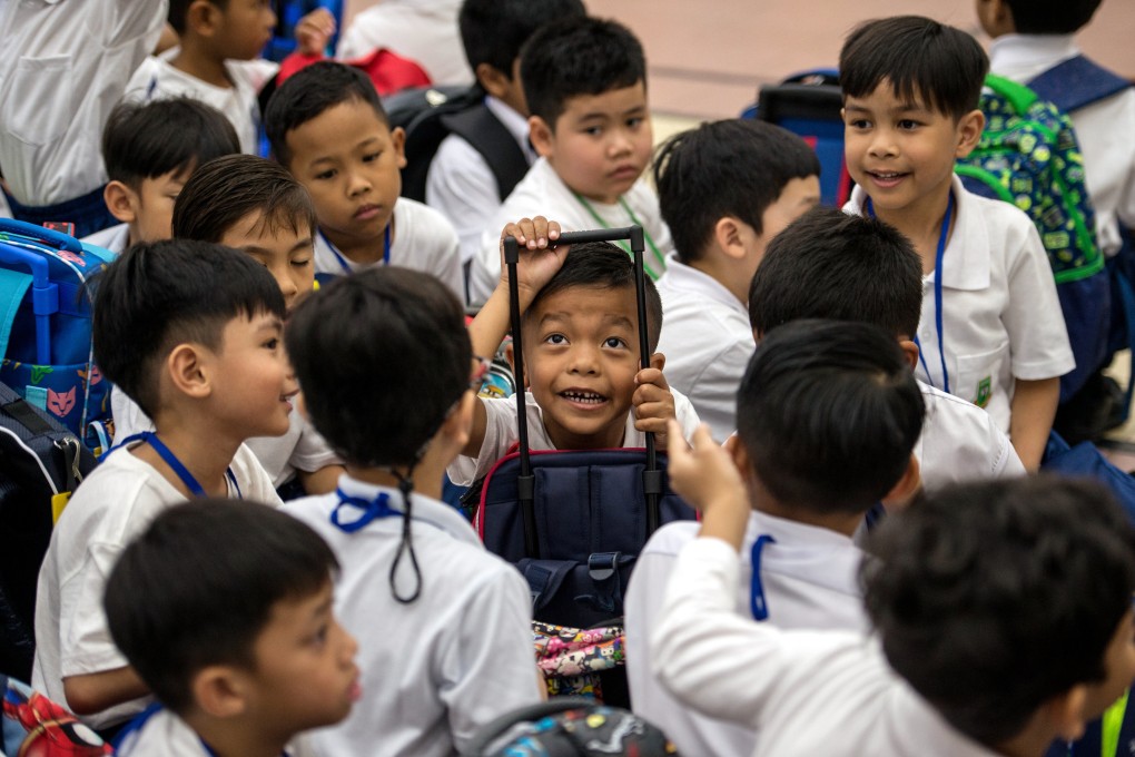 Malaysian students seen with their bags during the first day of schooling for the 2020 session at the Taman Tun Dr Ismail National School. Photo: DPA
