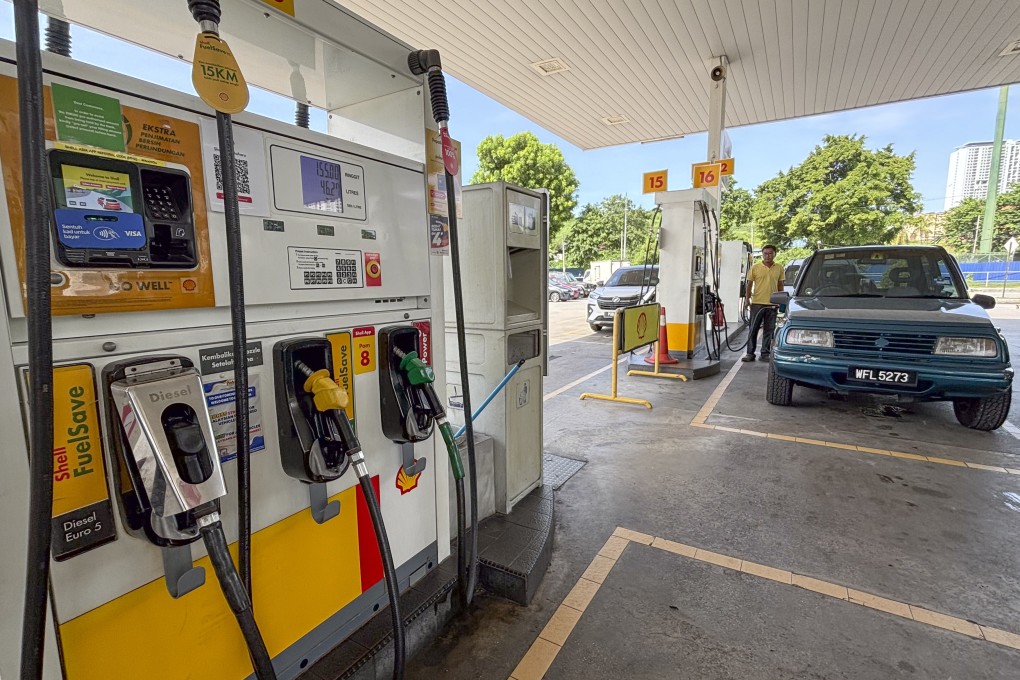 A car owner pumps at a petrol station in Kuala Lumpur. The Malaysian government is expected to announce a cut in petrol subsidies. Photo: AP