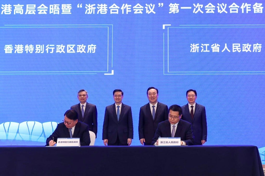 Hong Kong leader John Lee (standing second from left) at the signing ceremony with Zhejiang province officials. Photo: Handout