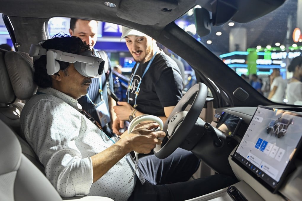 A foreign buyer uses a VR headset in a new energy vehicle at the China Import and Export Fair on April 19 in Guangzhou. Photo: China News Service/VCG via Getty Images