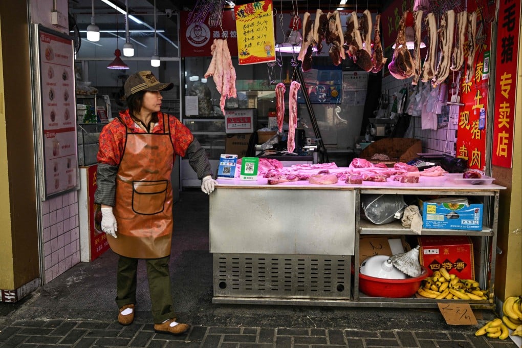 A vendor waits for customers at a meat shop in Shanghai earlier this month. Photo: AFP