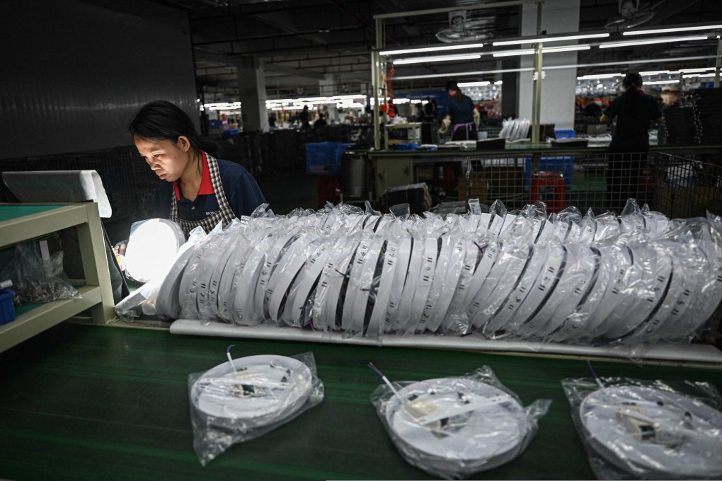 Employees work on an assembly line of lights at a factory of LED lighting manufacturer WOSEN in Zhongshan, in southern China’s Guangdong province on April 17, 2025. Photo: AFP