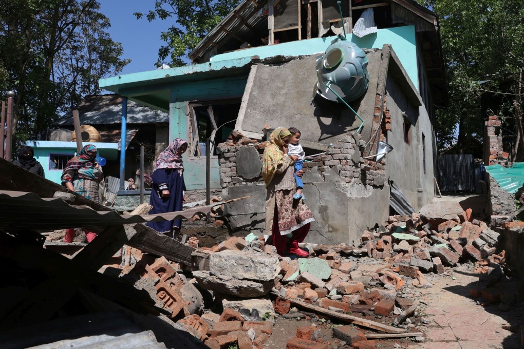 Women in the village of Tral in Kashmir walk past the demolished family home of Asif Sheikh, suspected of involvement in Tuesday’s deadly attack on tourists in Pahalgam. The houses of two suspected militants were destroyed by India’s security services. Photo: EPA-EFE