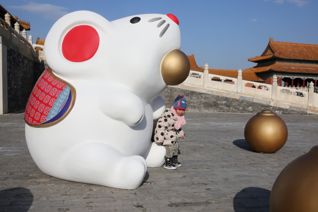 A child sits on an installation of a rat at the Forbidden City in Beijing, China. Feng shui master Andrew Kwan breaks down this lunar month’s prospects for Rats and those born under the other 11 Chinese zodiac signs. Photo: Reuters