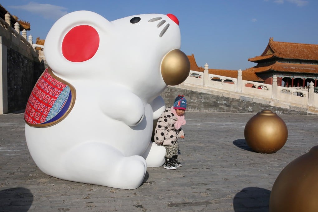 A child sits on an installation of a rat at the Forbidden City in Beijing, China. Feng shui master Andrew Kwan breaks down this lunar month’s prospects for Rats and those born under the other 11 Chinese zodiac signs. Photo: Reuters