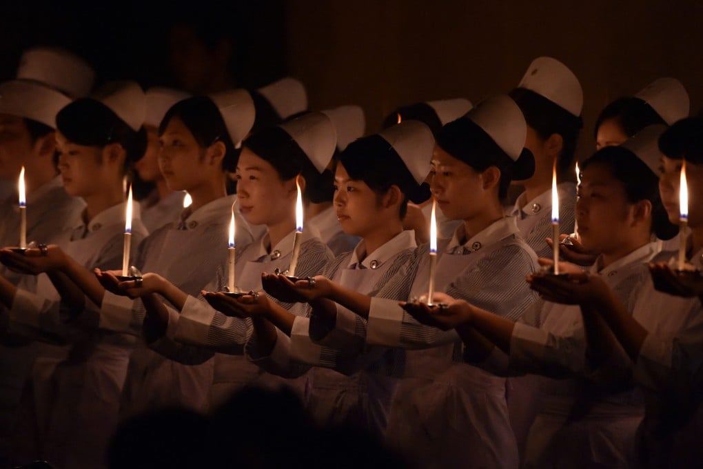 Students of Japanese nursing schools attend a candlelight procession before a Florence Nightingale Medal awarding ceremony in Tokyo. Photo: AFP