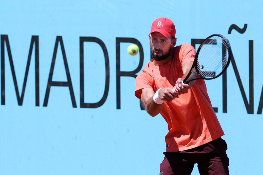 Novak Djokovic returns a shot to Frances Arthur Fils during a training session at the ATP Tour Madrid Open on Thursday. Photo: AFP