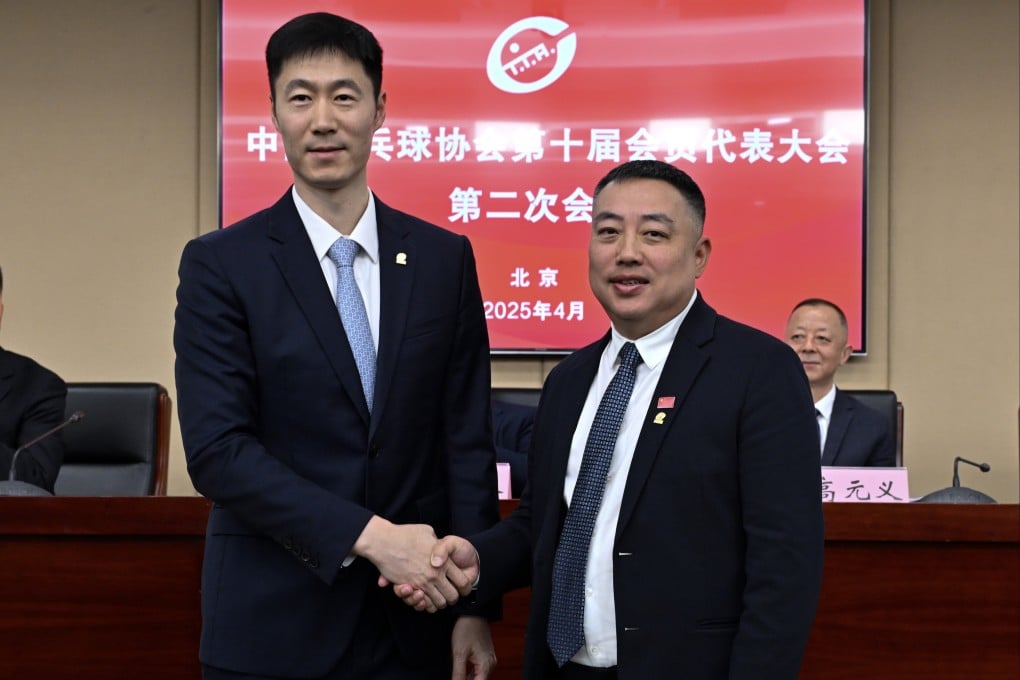 Wang Liqin (left), newly elected president of the Chinese Table Tennis Association, with his predecessor, Liu Guoliang, in Beijing on Wednesday. Photo: Xinhua