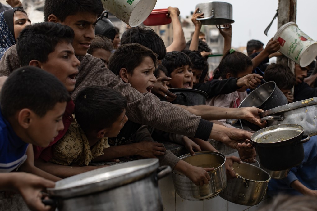 Palestinians receiving food from a charity kitche in Jabalia, Gaza. The UN’s World Food Programme says it has depleted its food stocks. Photo: EPA-EFE