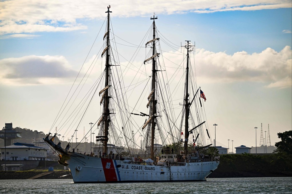 A man takes pictures as the US coastguard training vessel Eagle passes through the Panama Canal on Wednesday. Photo: AFP