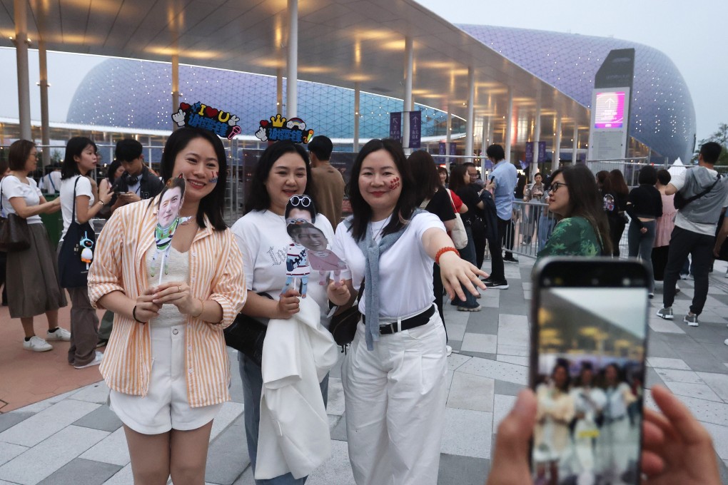 Fans pose for photos outside Kai Tak Stadium on Sunday. Photo: Jonathan Wong
