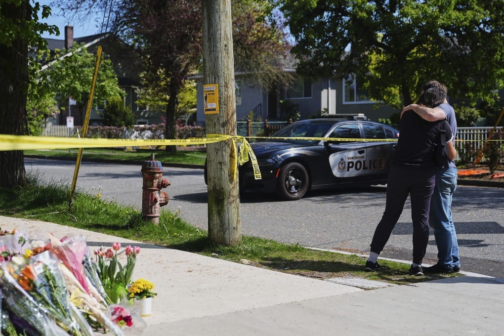 A couple hugs near the scene of the Vancouver attack. Photo: AP