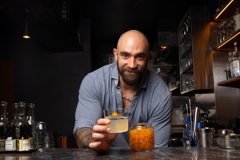 Jack Byrne, manager of Paragon, presents the Rosas Milk Punch. The cocktail is topped with a gummy made from upcycled citrus. Photo: Alexander Mak