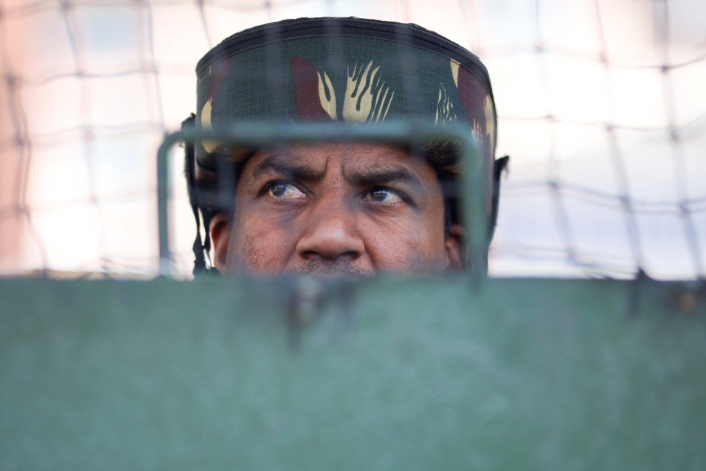 A member of Indian security personnel stands guard on a street in Srinagar, Kashmir, on Monday. Photo: Reuters