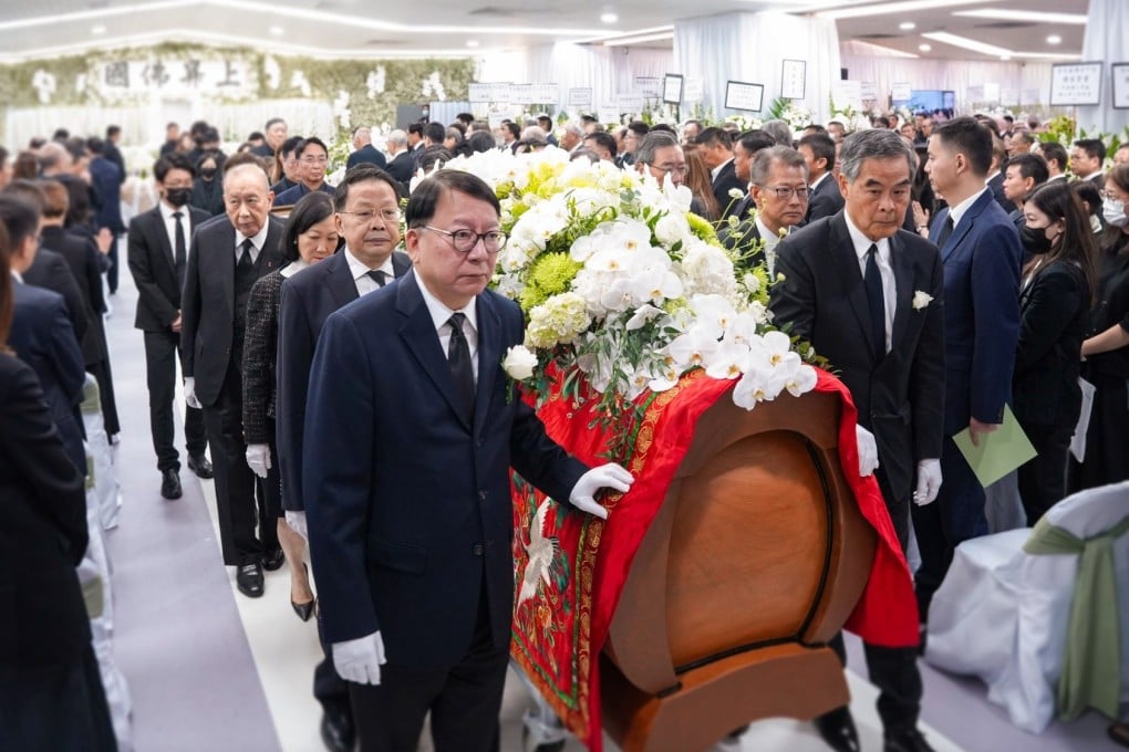 Chief Secretary Eric Chan (front left) and former leader Leung Chun-ying (front right) were among political and business heavyweights who walked with the late tycoon’s coffin. Photo: Handout