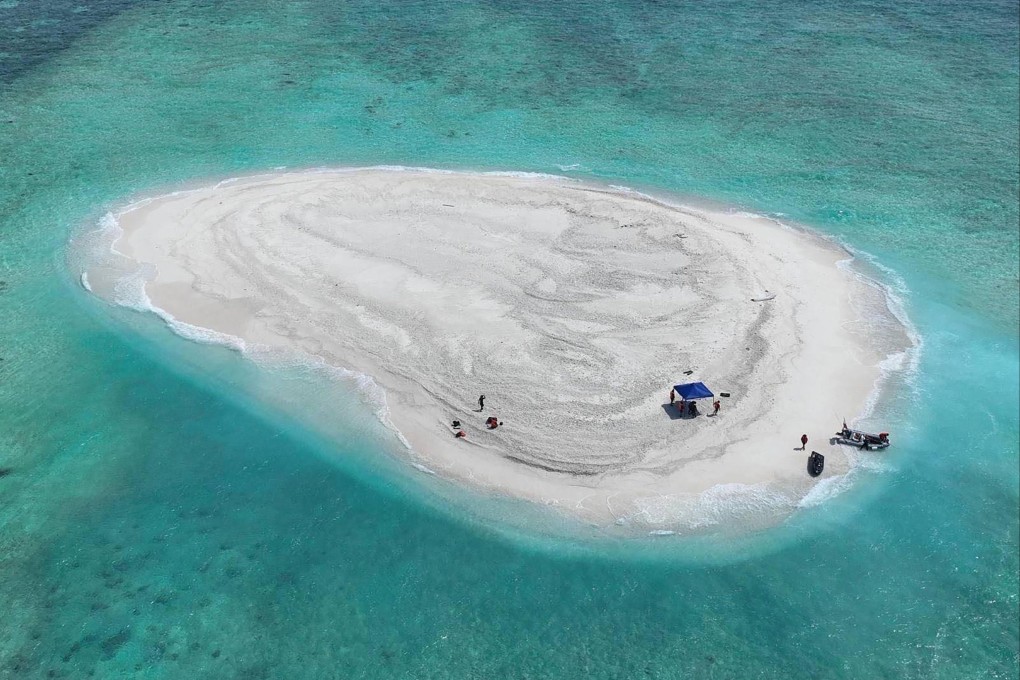 Scientists from the Philippines inspect Sandy Cay in the South China Sea on March 21 of last year. The contested reef has become a flashpoint for maritime tensions between Beijing and Manila. Photo: AFP/Philippine Coast Guard/Bureau of Fisheries and Aquatic Resources