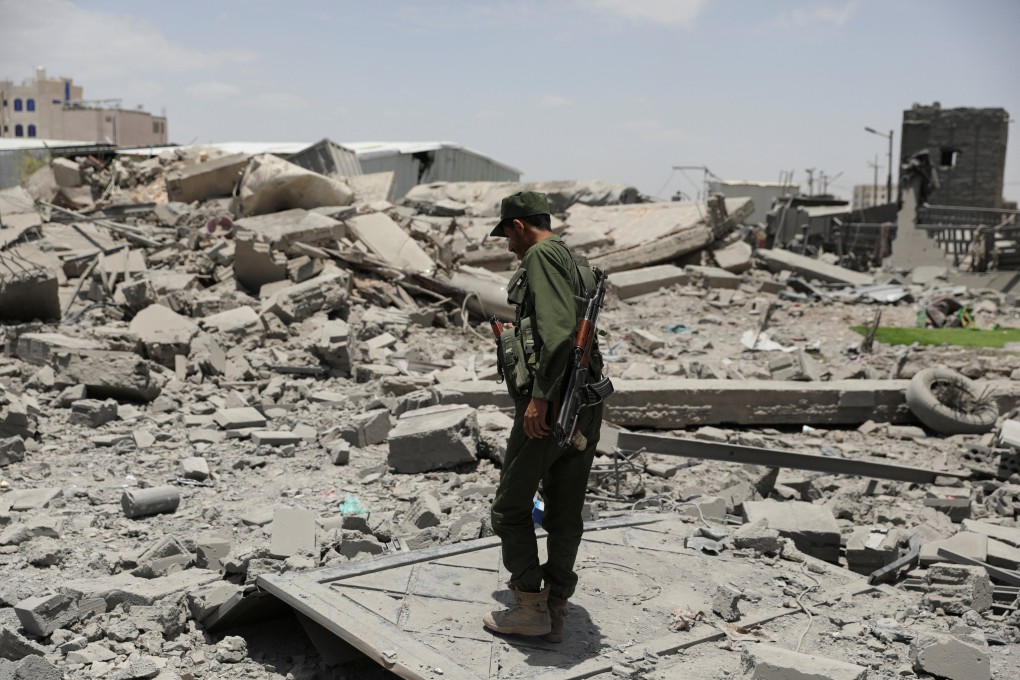 A police trooper stands on the rubble of a building destroyed by US air strikes in Sanaa, Yemen. Photo: Reuters