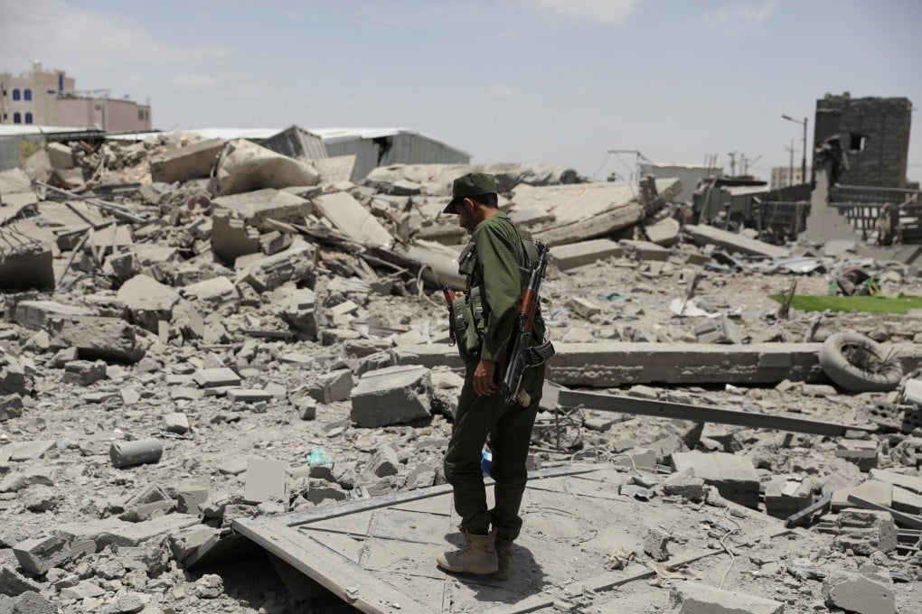 A police trooper stands on the rubble of a building destroyed by US air strikes in Sanaa, Yemen. Photo: Reuters