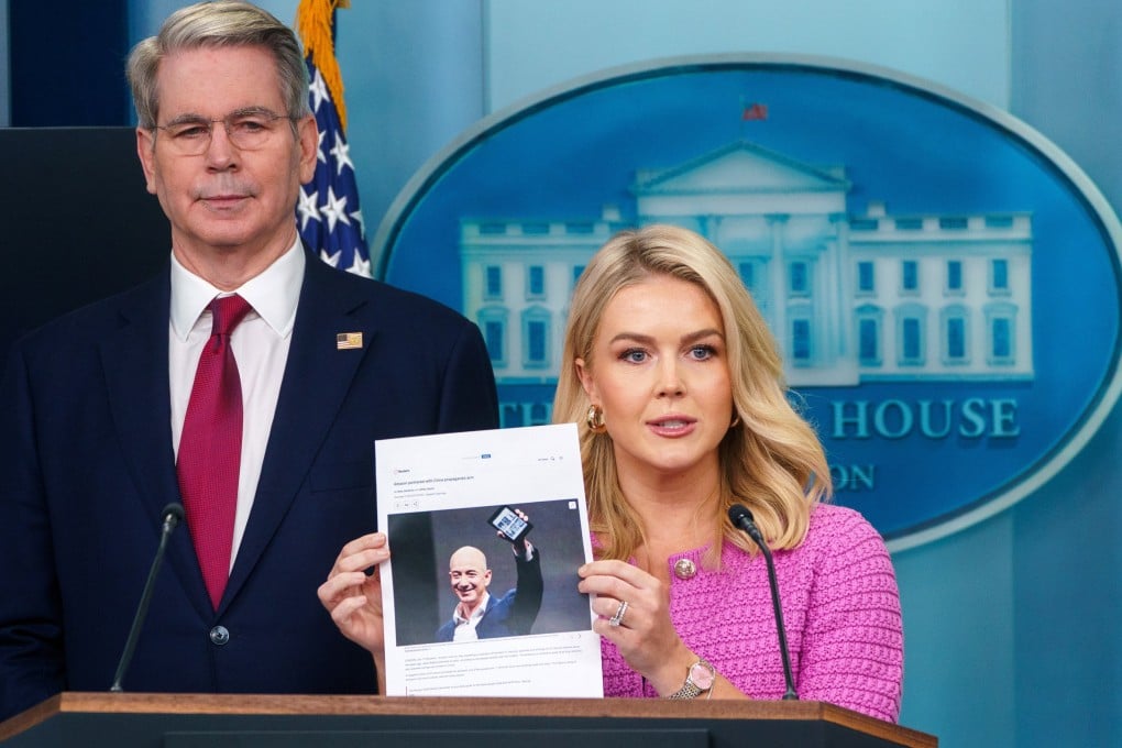 White House Press Secretary Karoline Leavitt holding a photograph of Amazon founder Jeff Bezos during a briefing with US Treasury Secretary Scott Bessent at the White House on Tuesday. Photo: EPA-EFE