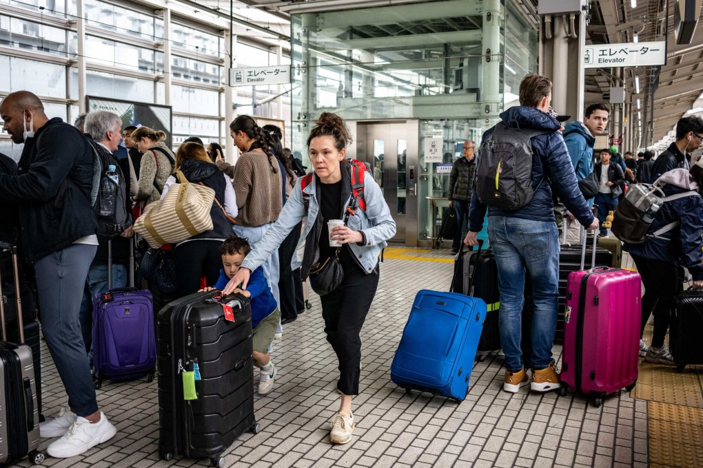 Foreign tourists gather on a platform at Kyoto station on April 16. Photo: AFP