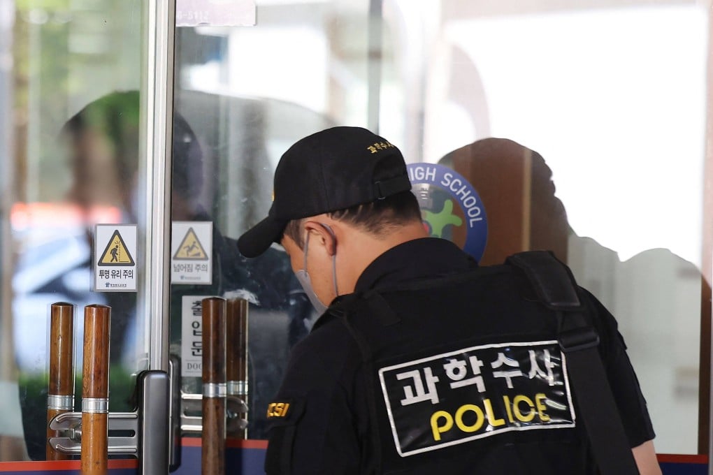 Members of a South Korean Police Crime Scene Investigation team probe at a high school in Cheongju on April 28, 2025, after a knife attack by a student. Photo AFP