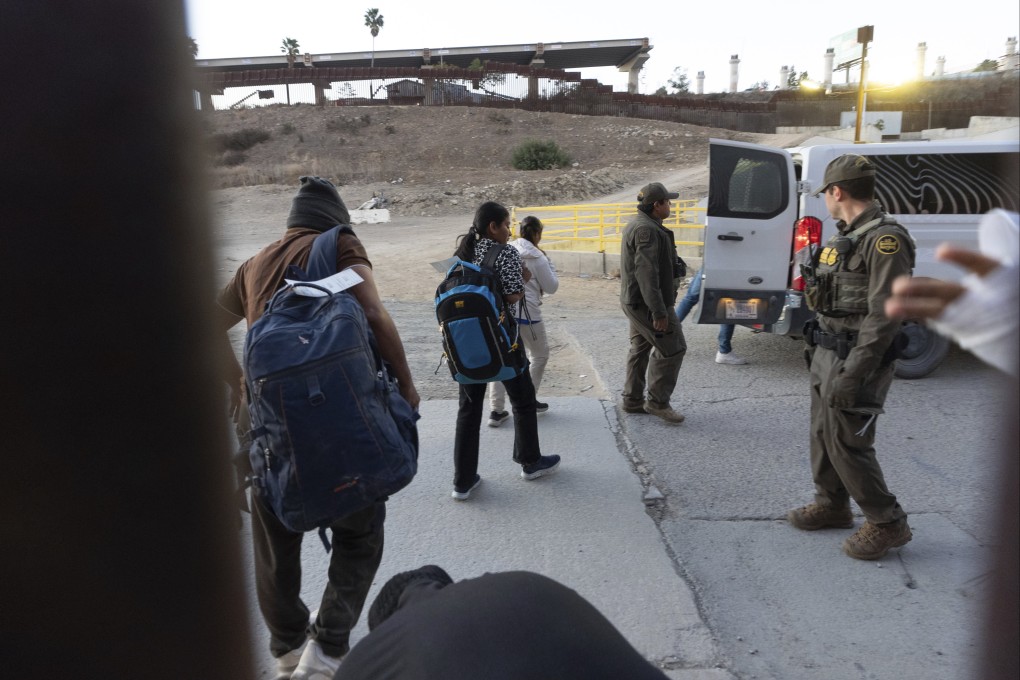 Migrants make their way to a Border Patrol van after crossing illegally and waiting to apply for asylum, in San Diego, California, US. Republicans on Monday proposed charging asylum seekers US$1,000 per application. Photo: AP