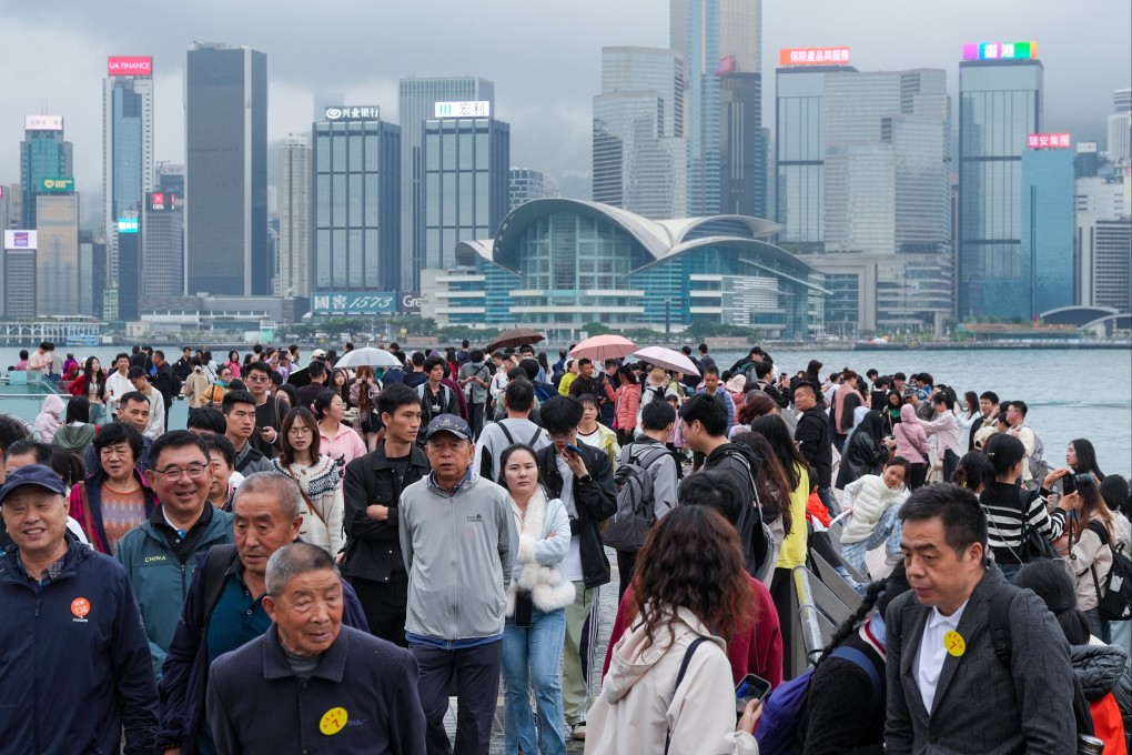 Tourists visit the Tsim Sha Tsui waterfront on a foggy and drizzly day earlier this month. Photo: Eugene Lee