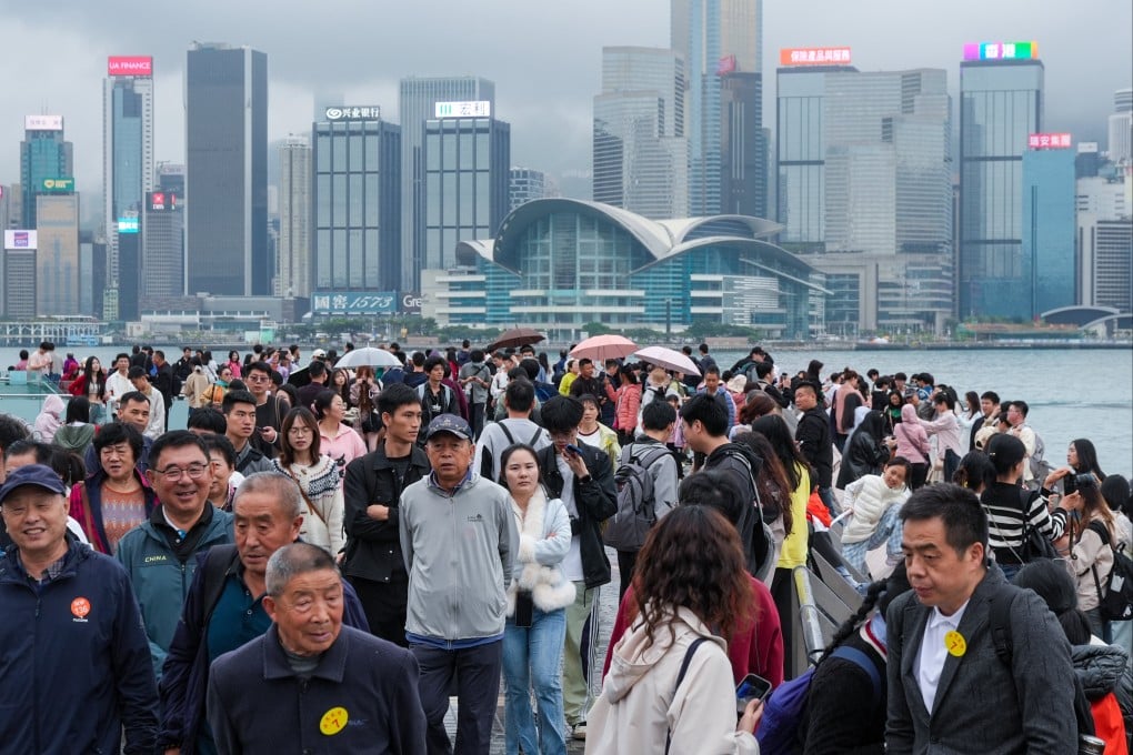 Tourists visit the Tsim Sha Tsui waterfront on a foggy and drizzly day earlier this month. Photo: Eugene Lee