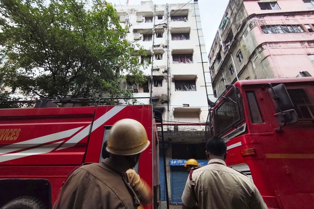 Firefighters inspect a hotel building in Kolkata, India, that caught fire late on Tuesday resulting in several deaths. Photo: AP