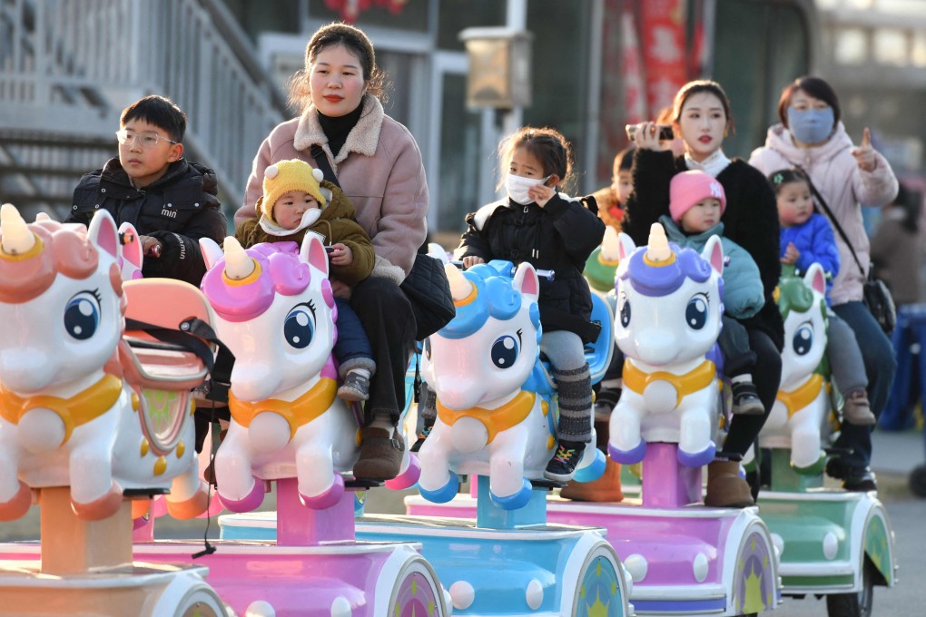 Children ride with adults in a park in Fuyang, in east China’s Anhui province, on January 16. China said on January 17 that its population fell for the third year running in 2024, extending a downward streak after more than six decades of growth as the country battles a looming demographic crisis. Photo: AFP