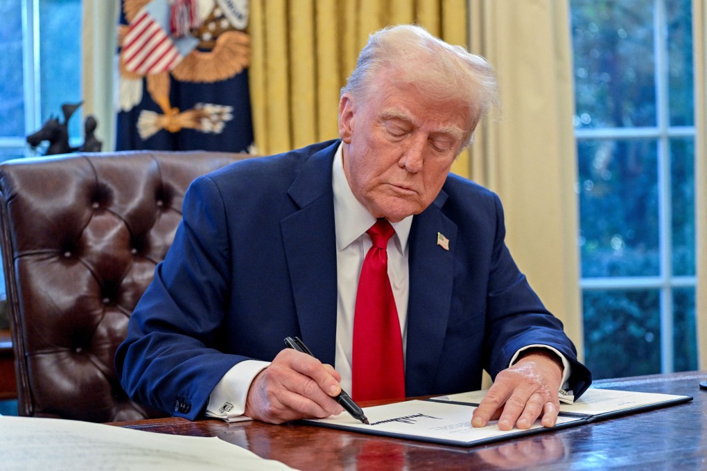 US President Donald Trump signs an executive order in the Oval Office of the White House on January 30. He signed 141 such orders in the first 100 days of his presidency. Photo: AFP/Getty Images/TNS