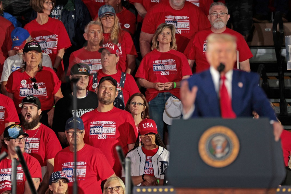 Car workers listen as US President Donald Trump marks his 100th day in office at Macomb Community College in Warren, Michigan on April 29. Photo: AFP