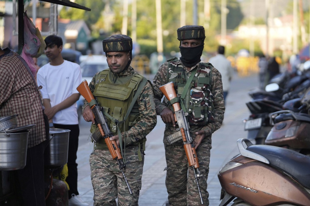 Indian paramilitary soldiers patrol a busy market in Srinagar in Indian-controlled Kashmir on Tuesday. Photo: AP