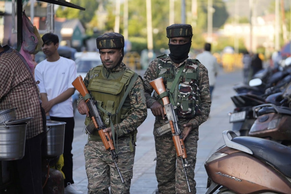 Indian paramilitary soldiers patrol a busy market in Srinagar in Indian-controlled Kashmir on Tuesday. Photo: AP