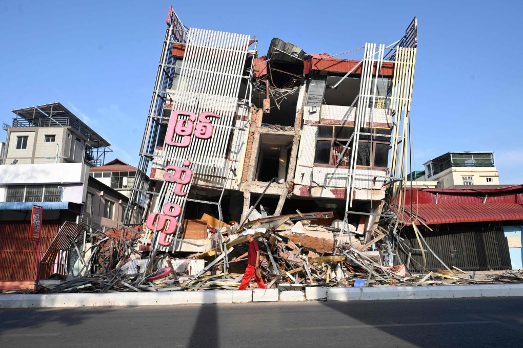 A man walks past a damaged building in Mandalay, Myanmar on April 13, 2025, following the devastating March earthquake. Photo: AFP