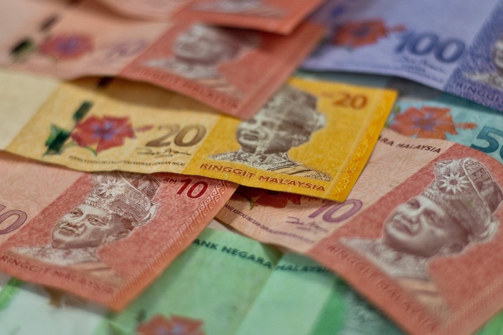 A woman said she borrowed money from relatives and friends to settle her son’s 30,000 ringgit debt. Photo: AFP