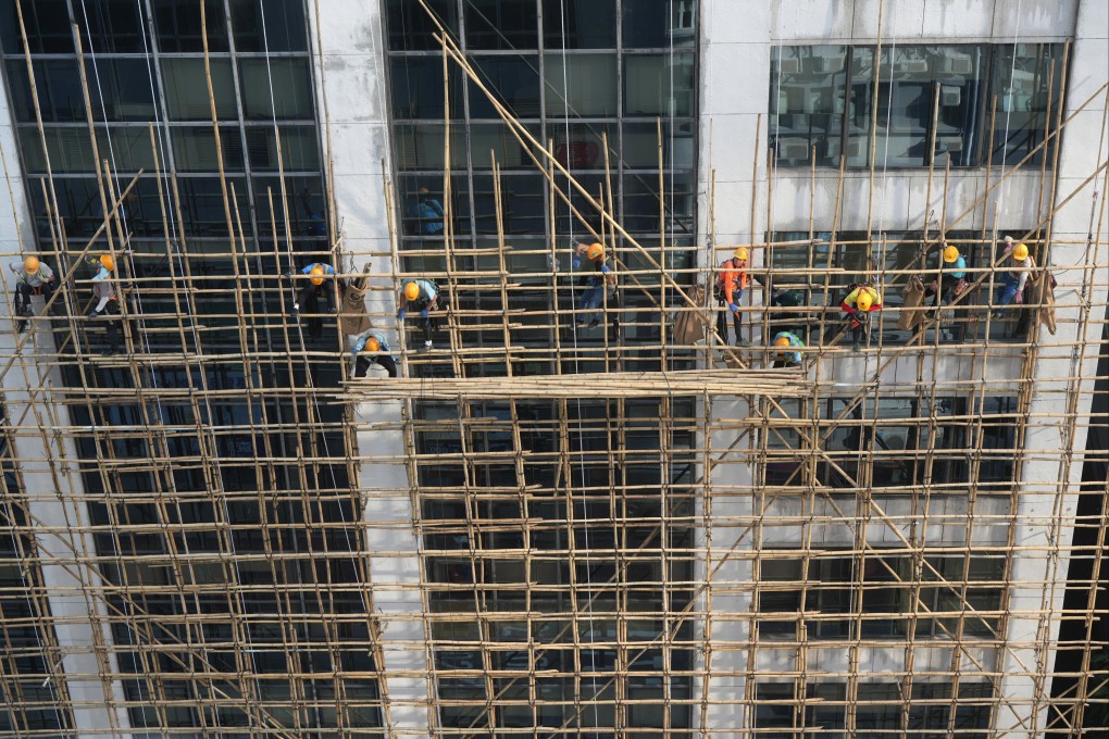 Workers are seen on scaffolding on Hong Kong Tower at King’s Road, North Point. Photo: Sam Tsang