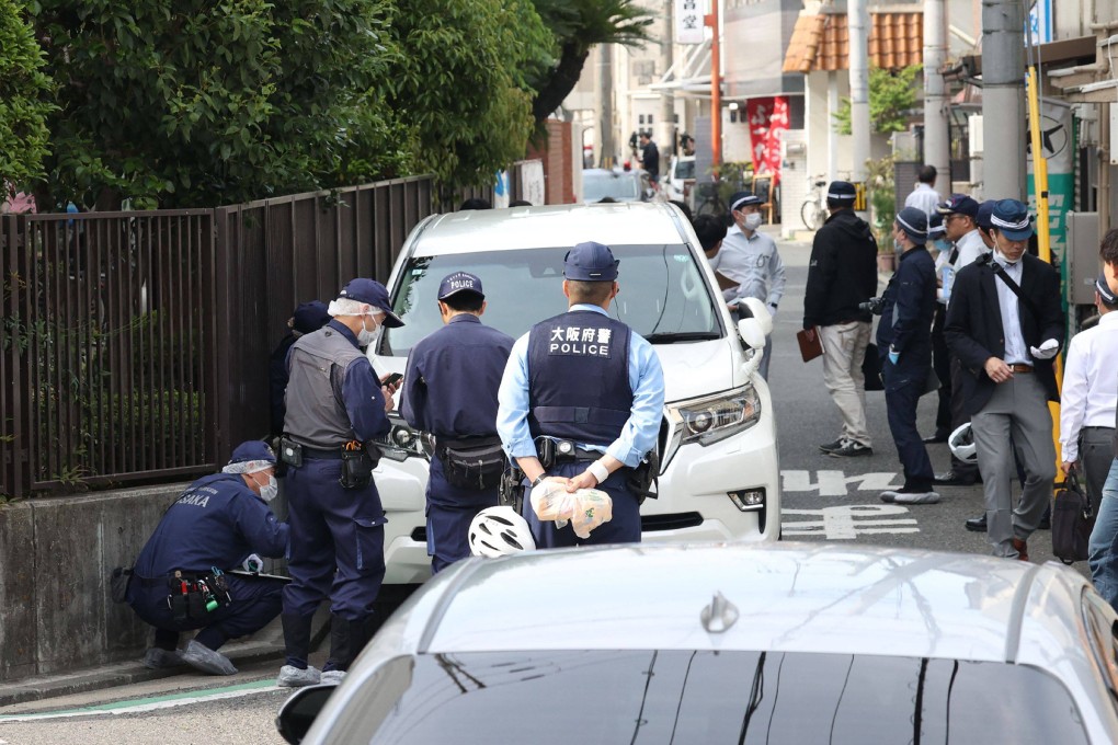 Police officers investigate the scene in Osaka’s Nishinari district on Thursday after a man was arrested for ploughing his car into seven schoolchildren in a suspected deliberate attack. Photo: AFP