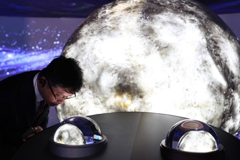 A visitor looks at lunar soil samples collected by China’s Chang’e-5 and Chang’e-6 missions at the Osaka Expo in Japan. Photo: Xinhua