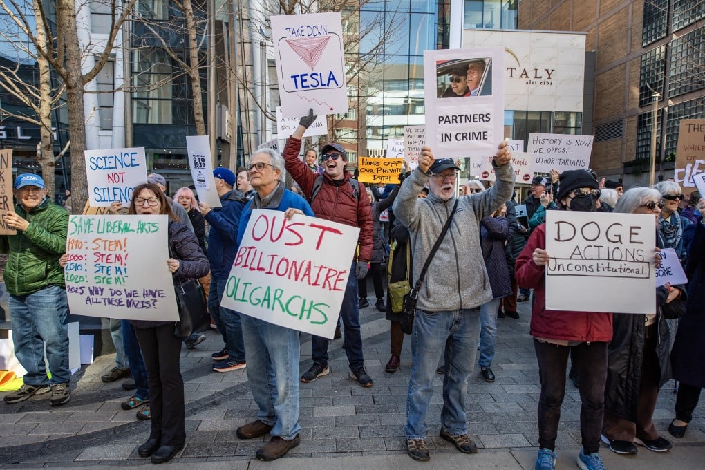 People protest against Elon Musk and Tesla outside a Tesla showroom in Boston, US, on March 15. Photo: FP/Getty Images/Tribune News Service