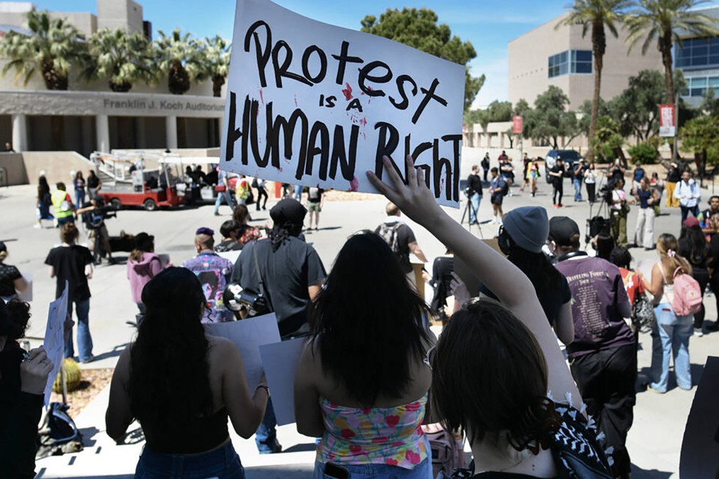 A student waves a sign during a University of Nevada, Las Vegas, rally to demand the university protect students regardless of immigration status on April 24. Photo: TNS