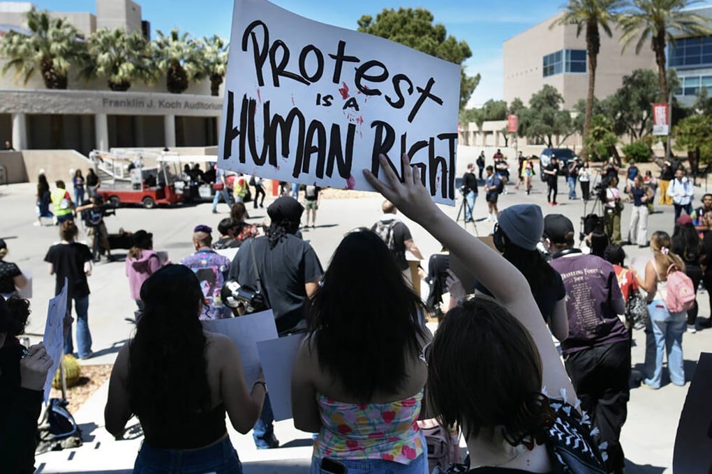 A student waves a sign during a University of Nevada, Las Vegas, rally to demand the university protect students regardless of immigration status on April 24. Photo: TNS