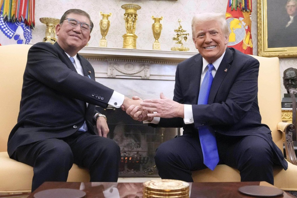 Japanese Prime Minister Shigeru Ishiba (left) shakes hands with US President Donald Trump at the White House on February 7. Photo: Kyodo