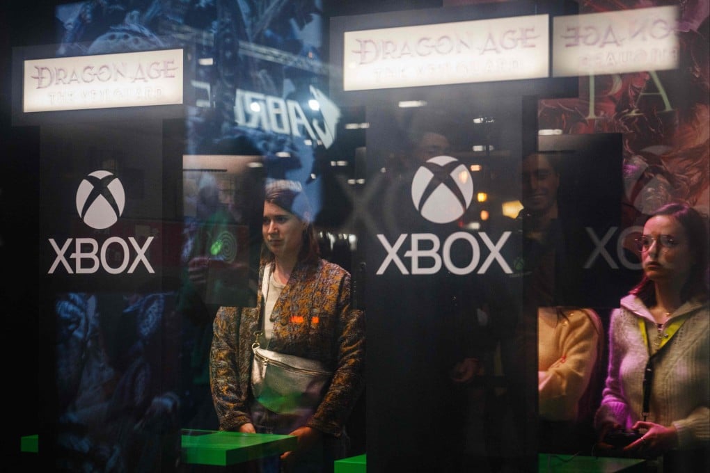 Visitors play games on Xbox consoles during a video game fair in Paris. Photo: AFP